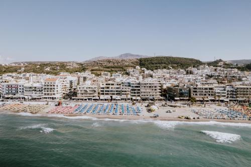 an aerial view of a beach with white buildings at Palm Beach Hotel Apartments in Rethymno Town
