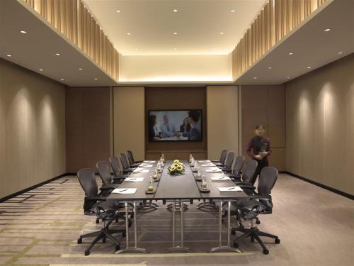 a large conference room with a long table and chairs at PARKROYAL on Beach Road, Singapore in Singapore