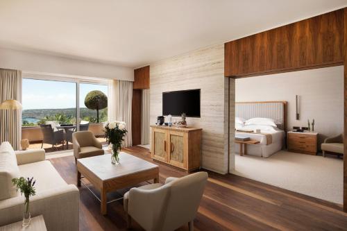 a hotel room with a bed and a living room at Grecian Park in Protaras