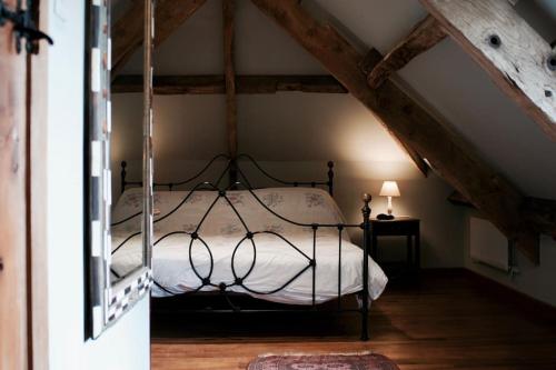 a bedroom with a bed in a attic at Beautiful farmhouse near Abergavenny - Sleeps 6-26 in Grosmont