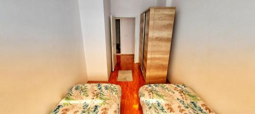 a hallway with two beds in a room at Sunflower Apartments in Pristina