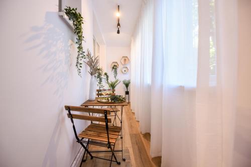 a small hallway with a table and a chair at Lemonade - Stylish 1BR Apartment in Obor District in Bucharest
