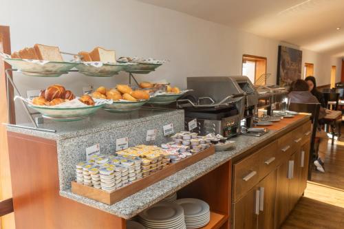 a buffet line with plates and bowls of food at Casa Andina Standard Cusco Plaza in Cusco