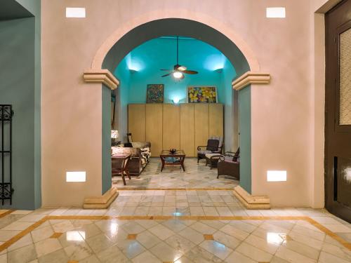 a living room with an archway in a house at Casona 66 Merida Boutique Hotel in Mérida
