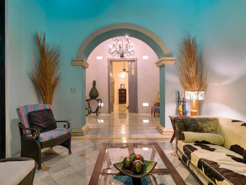 a living room with a couch and a table at Casona 66 Merida Boutique Hotel in Mérida