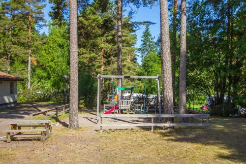 a playground in a park next to some trees at Karlstad Swecamp Bomstadbaden in Karlstad
