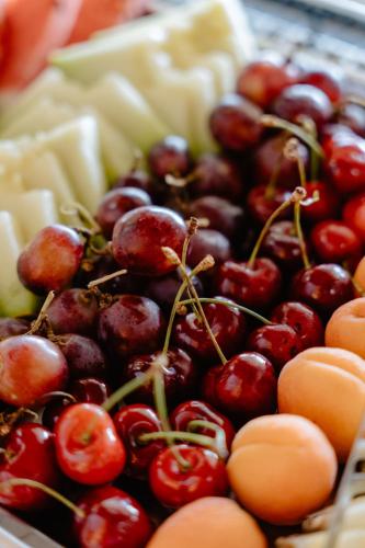 a pile of cherries and other fruits and vegetables at Palm Beach Hotel Apartments in Rethymno Town