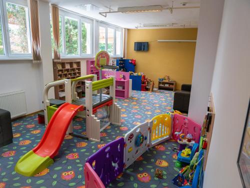 a childrens play room with slides and play equipment at Hunguest Hotel Gyula in Gyula