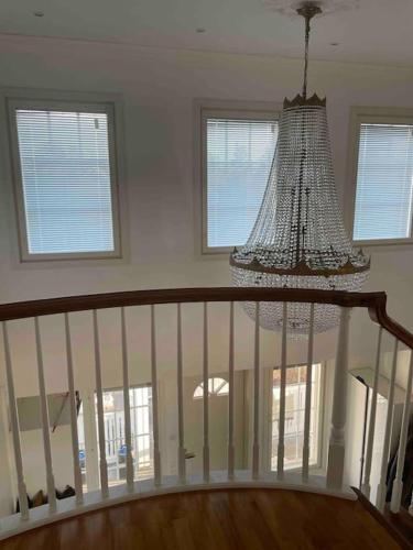 a chandelier hanging over a staircase in a house at Luxury villa with stunning view in Pargas