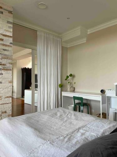 a bedroom with a bed and a desk with chairs at Luxury villa with stunning view in Pargas