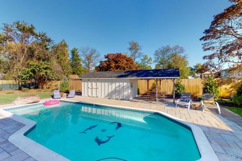 a swimming pool in a backyard with a shed at Pasadena Retreat in Glen Burnie