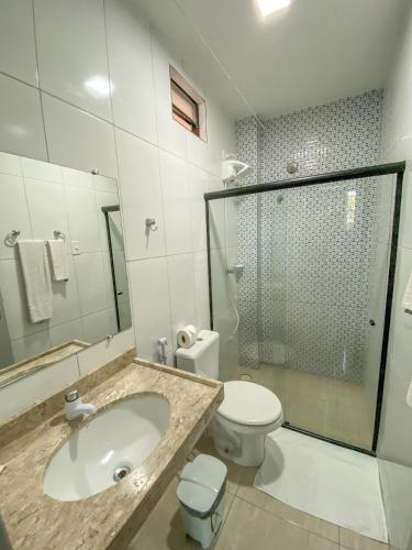 a bathroom with a sink and a toilet and a shower at Pousada Talha - Mar in Maragogi