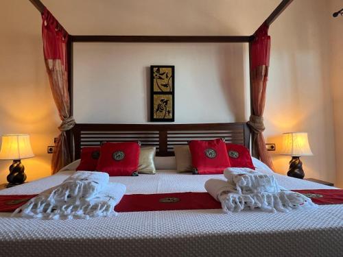 a bedroom with a large bed with red pillows at The Marbella Heights Boutique Hotel in Marbella