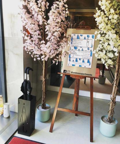 a easel with a sign next to two trees at Perfect for Work Stays - Apartment 4 in Gillingham