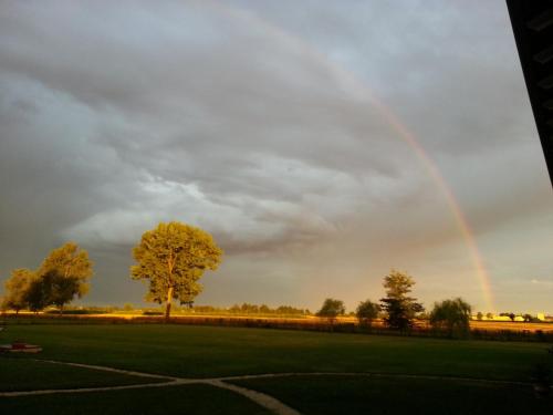 a rainbow in the sky over a field at Il Rifugio del Poeta in San Biagio di Callalta