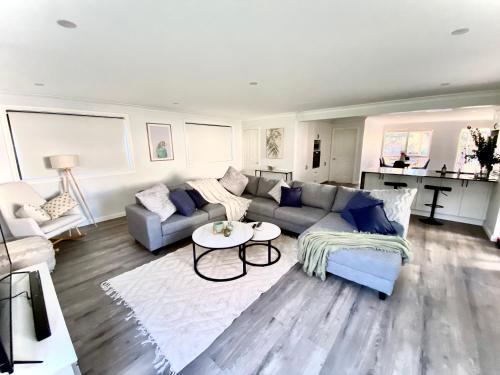 a living room with a couch and a table at Relaxing 3 bedroom house with 2 bathrooms. in Katoomba