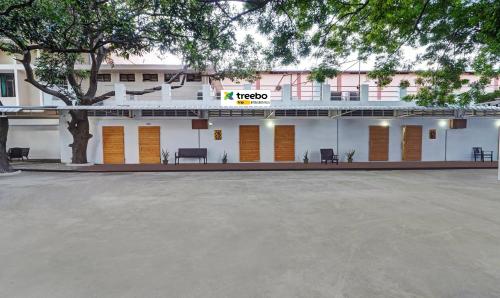 a large white building with a sign on it at Itsy By Treebo - Green Villaa 2 Km From Pondicherry Railway Station in Puducherry