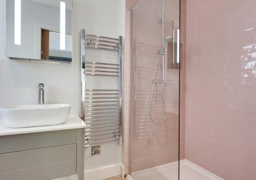 a bathroom with a sink and a shower at Daisys Barn in Mattishall