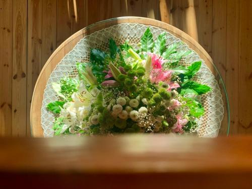 a bouquet of flowers sitting on a table at Karczma Leśniczanka in Wielbark