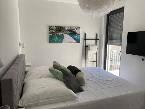 a bedroom with a bed with pillows on it at Penthouse Maus in Trogir