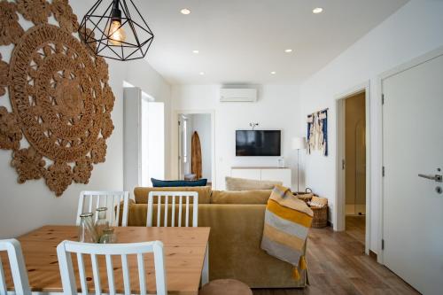 a living room with a couch and a table at Feel Nazaré - Abegoarias 62 in Nazaré