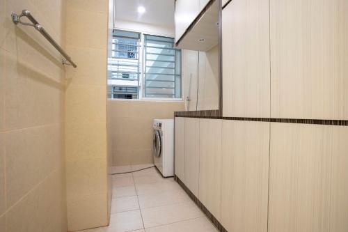 a bathroom with a washer and dryer at AJ Suites @ Loft Imago KK in Kota Kinabalu