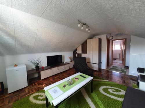 a living room with a couch and a table at Fortress apartments Niš in Niš