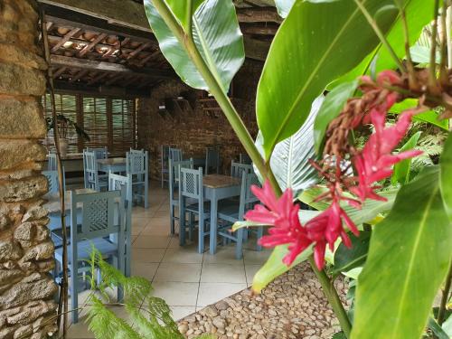 a restaurant with blue chairs and a red flower at Hotel Estalagem Porto Seguro in Porto Seguro
