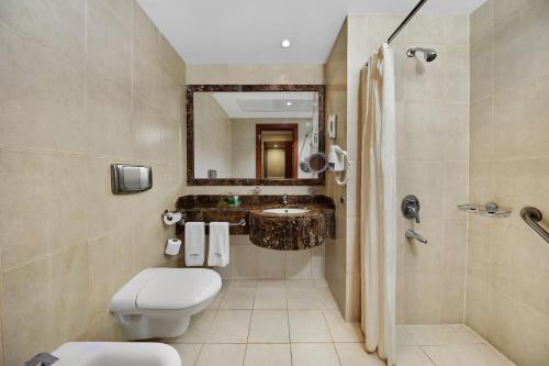 a bathroom with a toilet and a sink and a shower at Makarem Mina Hotel in Mecca