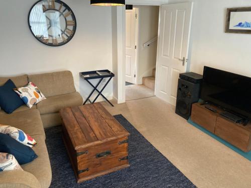 a living room with a couch and a coffee table at Cheerful Home FOR FOOTBALL, DOCKS AND CITY CENTRE in Liverpool