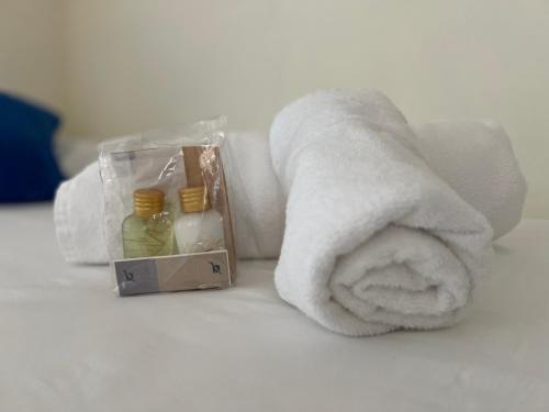 a towel and a box of medicine on a bed at IZARO EYE BERMEO by Urdaibai Rentals in Bermeo