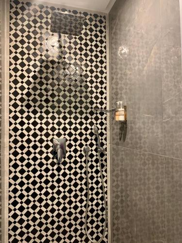 a bathroom with a shower with a glass door at Villa Margaux in Essaouira