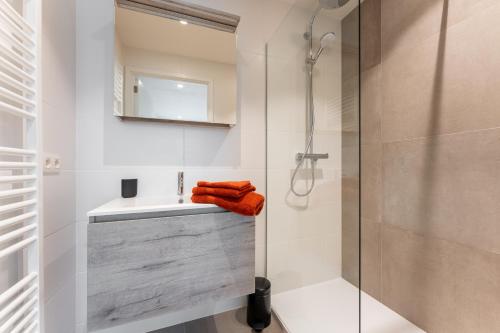 a bathroom with a sink and a shower at Duinenrij 197 in Bredene