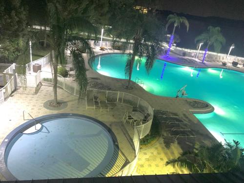 an overhead view of a swimming pool at night at Disney 1 mile , Blue Heron 1 room 2 bath,amenities,6 guests, walk to restaurants, no fees at check in in Orlando
