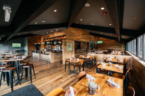 a restaurant with wooden floors and tables and chairs at Park City Peaks in Park City