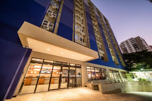 a large blue building with windows in a city at ibis Fortaleza Praia de Iracema in Fortaleza