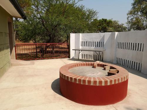 a fire pit in the middle of a patio at Crimson Bush Lodge in Klipdrift
