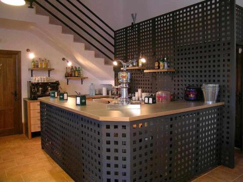 a bar in a restaurant with a counter in a room at Casas Rurales Venta Seca hasta 24 plazas in El Romero