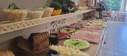 a buffet line with different types of food on plates at Dom Wczasowy Salamon in Poronin