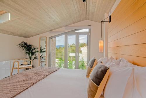 a bedroom with a large bed with a large window at My Mediterranean Corfu Luxury Villa with Private Swimming Pool in Kontokali