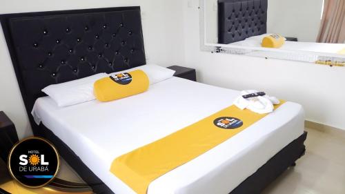 Postel nebo postele na pokoji v ubytování Hotel sol de uraba