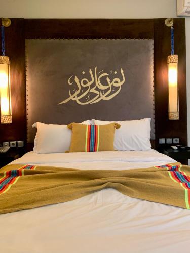 a bedroom with a large bed with a wall at Villa Margaux in Essaouira