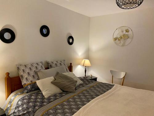 a bedroom with a bed with clocks on the wall at Gîte Edelweiss Saint-Martin-en-Vercors in Les Barnoux