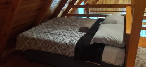 a bedroom with a bed with white sheets and pillows at Casa Kafka - Bio Cult in Campo Alegre