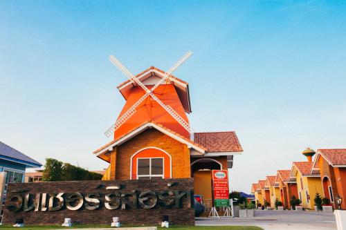a building with a windmill on top of it at Windsor Resort in Lop Buri