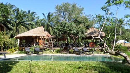 a resort with a swimming pool and a house at Huma Terra Lodges in Hikkaduwa