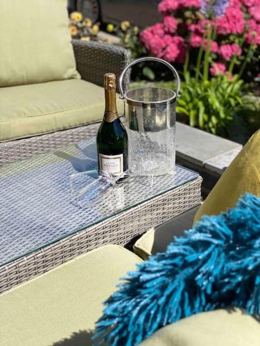 a bottle of champagne sitting on a table at Mumbles - Modern Apartment with panoramic sea views in Oystermouth