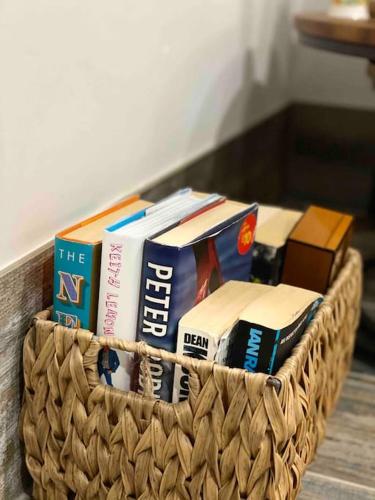a basket full of books sitting on a table at Mumbles - Modern Apartment with panoramic sea views in Oystermouth