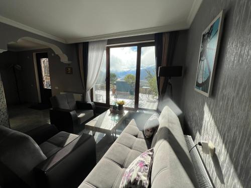 a living room with a couch and a table at UP in Stepantsminda