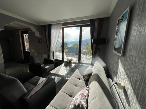 a living room with a couch and a table at UP in Kazbegi